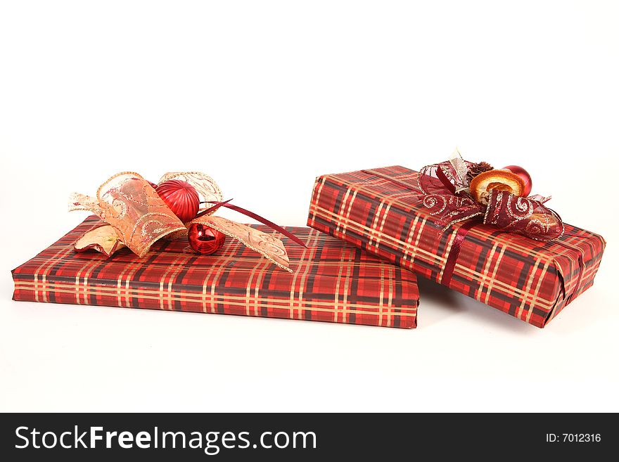 Two christmas presents in red paper with unusual decorations