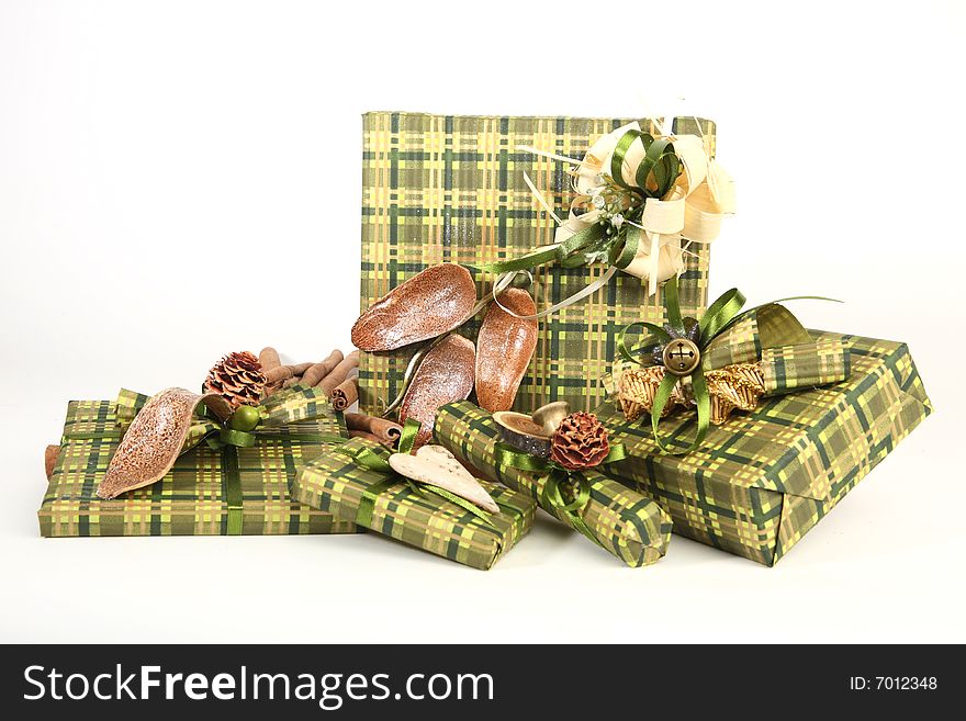 Five christmas presents in green paper with unusual decorations