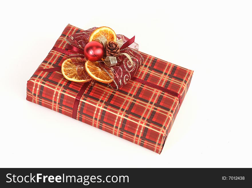 Christmas present in red paper with unusual decorations. Christmas present in red paper with unusual decorations
