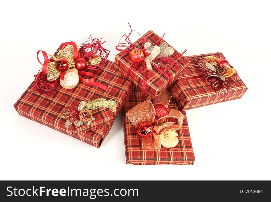 Four christmas presents in red paper with unusual decorations