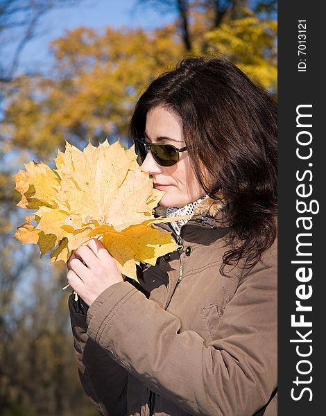 Woman with yellow leaves in autumn forest. Woman with yellow leaves in autumn forest