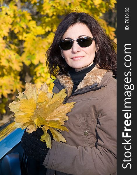 Woman with yellow leaves in autumn forest. Woman with yellow leaves in autumn forest