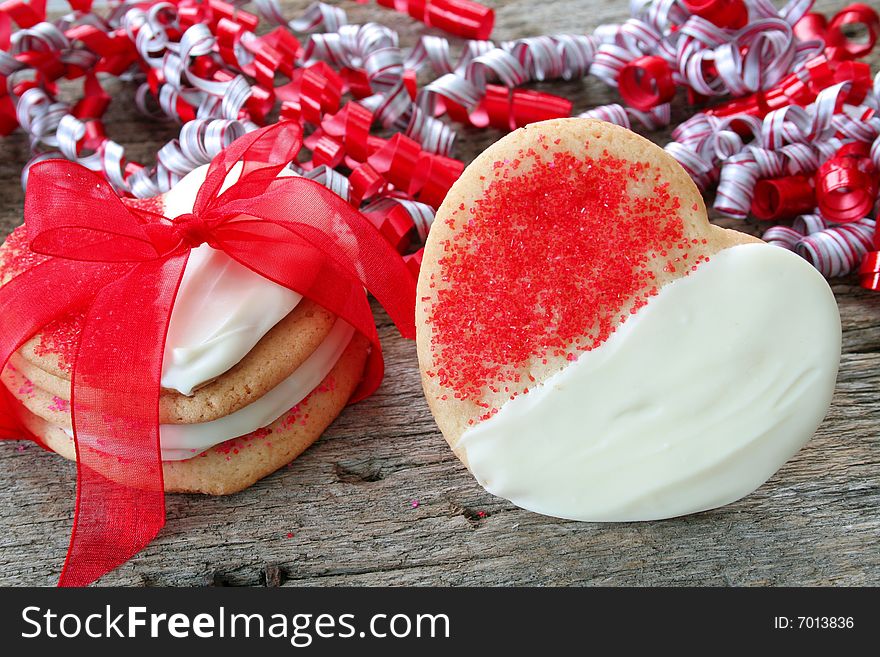 Heart shaped sugar cookies dipped with white chocolate and sprinkles. Heart shaped sugar cookies dipped with white chocolate and sprinkles.