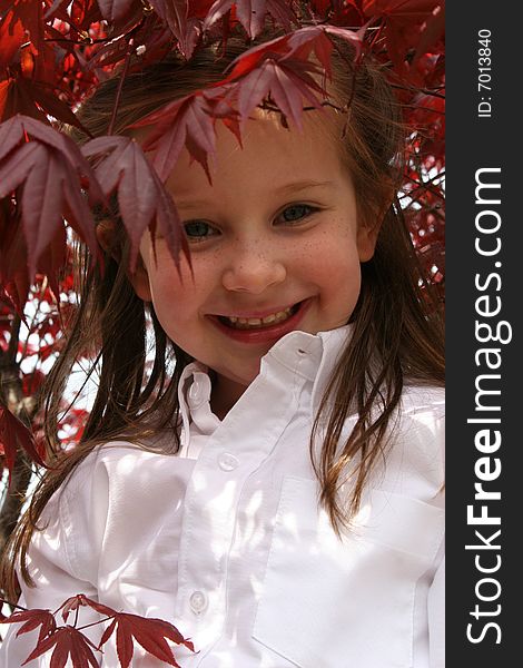 Little girl stands under a tree. Little girl stands under a tree