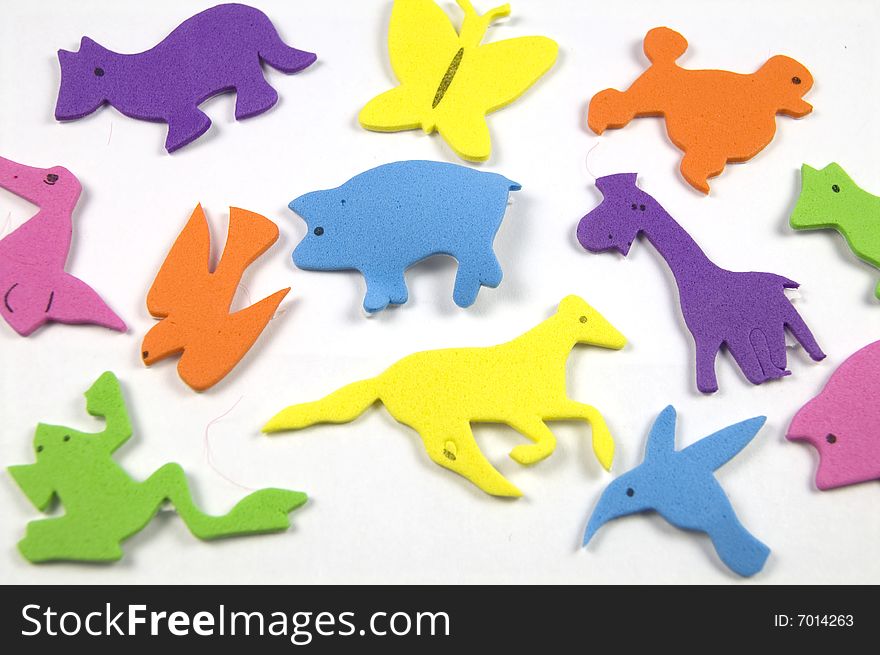 A photograph of colorful animals against a white background. A photograph of colorful animals against a white background