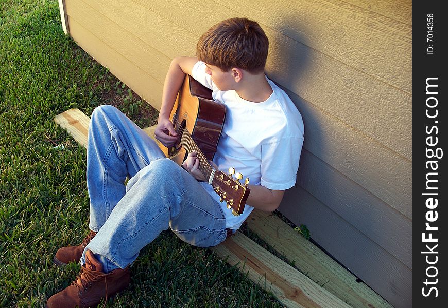 Boy Relaxing Playing Guitar