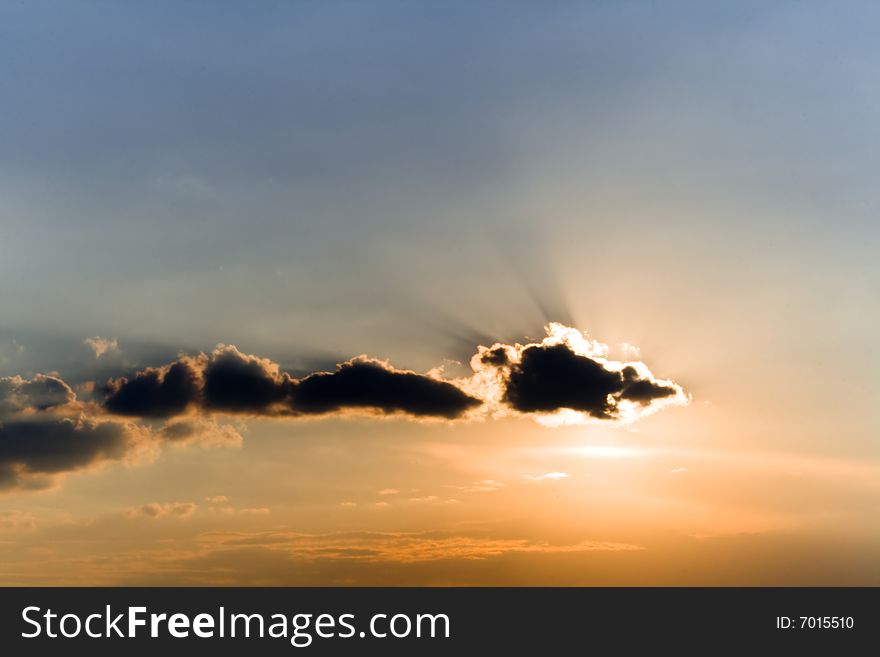 Beautiful clouds in sunset beams
