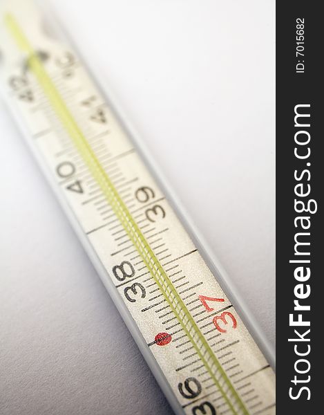 Medical thermometer detail on light grey background