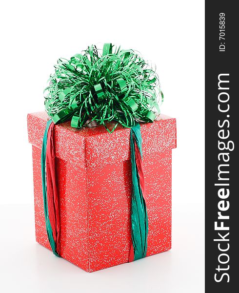 Red gift box with green decoraion on white background