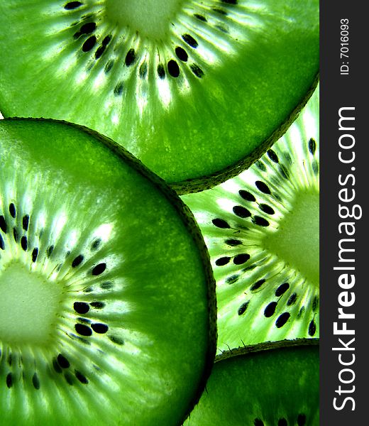 Macro photograph of sliced kiwifruit with light behind. Macro photograph of sliced kiwifruit with light behind