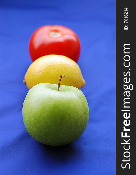 Concept of fruits representing traffic light on blue background (perspective with thin depth of field). Concept of fruits representing traffic light on blue background (perspective with thin depth of field)