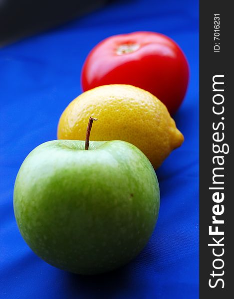 Concept of fruits representing traffic light on blue background (perspective with thin depth of field). Concept of fruits representing traffic light on blue background (perspective with thin depth of field)