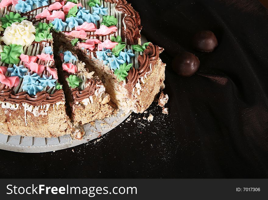 Cake with sweet and chocolate on the drapery with crumb. Cake with sweet and chocolate on the drapery with crumb