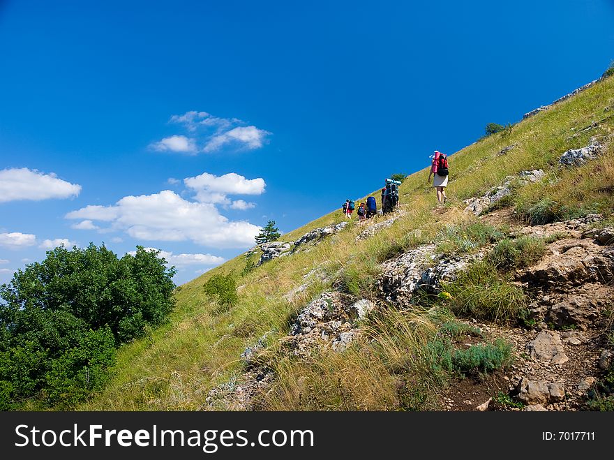 Group of hikers clamber in mountains