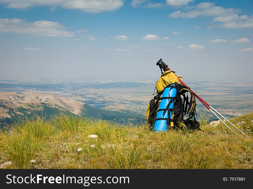 Summer mountain landscape with backpack in foreground. Summer mountain landscape with backpack in foreground