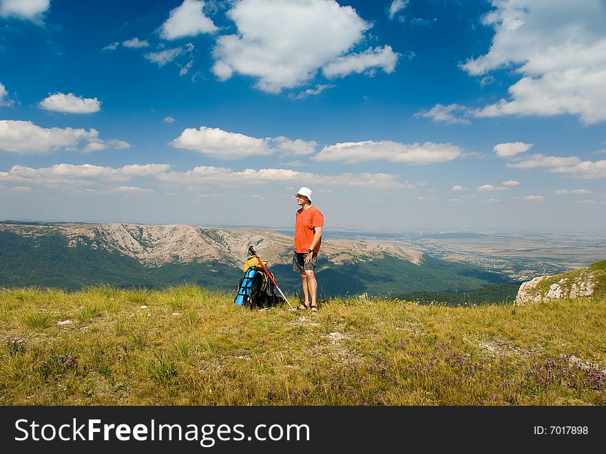 Happy hiker in mountains, beautiful landscape in background