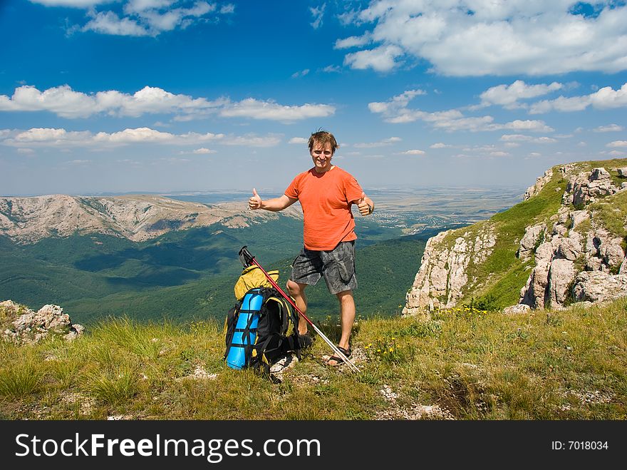 Happy hiker in mountains, beautiful landscape in background