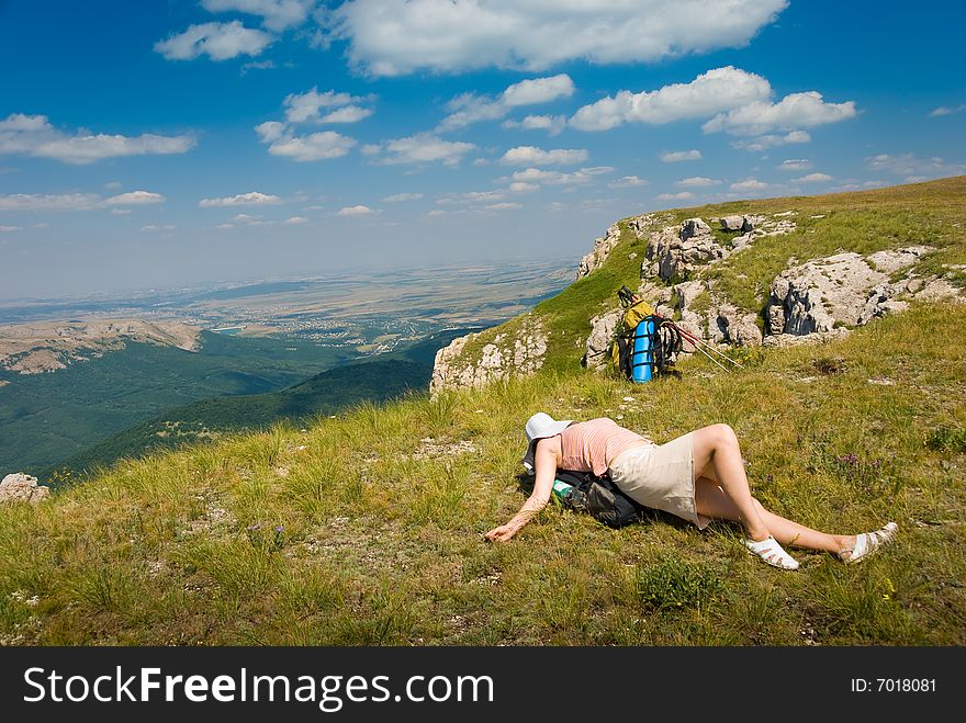Happy all-in hiker relaxes in mountains. Happy all-in hiker relaxes in mountains