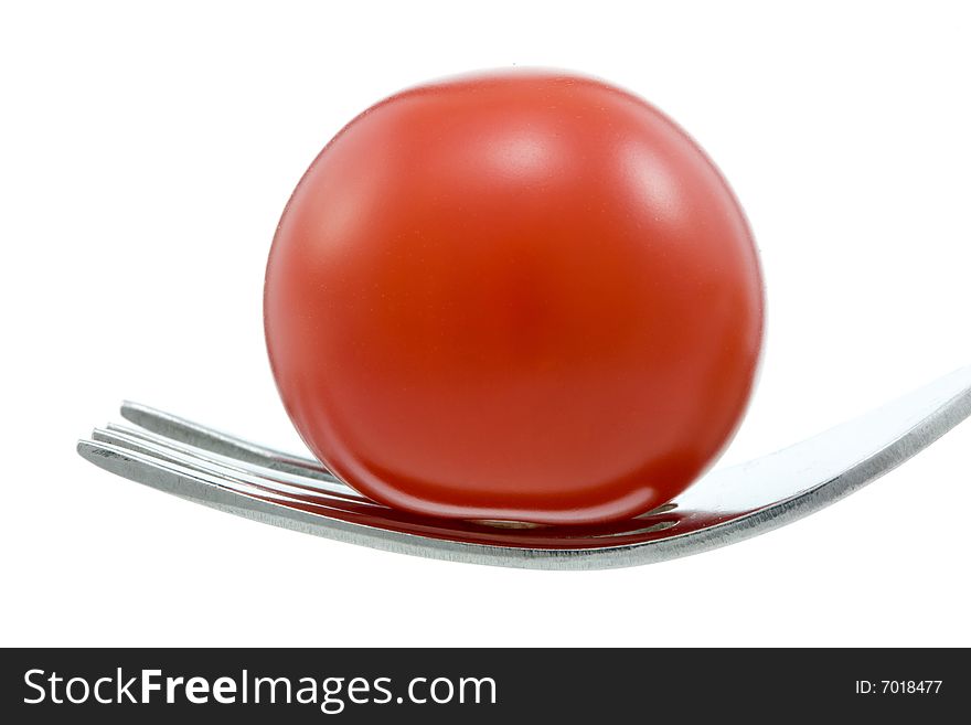 Cherry tomato and fork on white. Cherry tomato and fork on white.