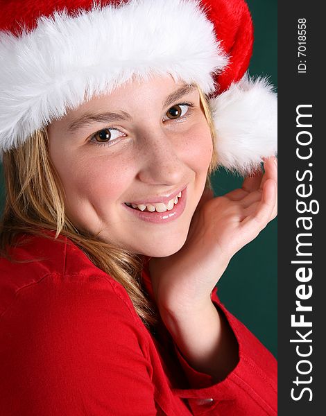 Beautiful teenager wearing a red shirt and christmas hat. Beautiful teenager wearing a red shirt and christmas hat