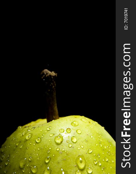 Close up of a fresh pear isolated on black