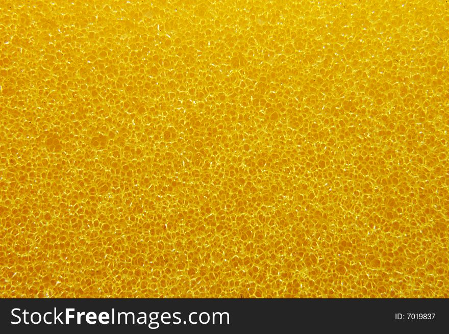 A macro shot of a bright yellow sponge. A macro shot of a bright yellow sponge