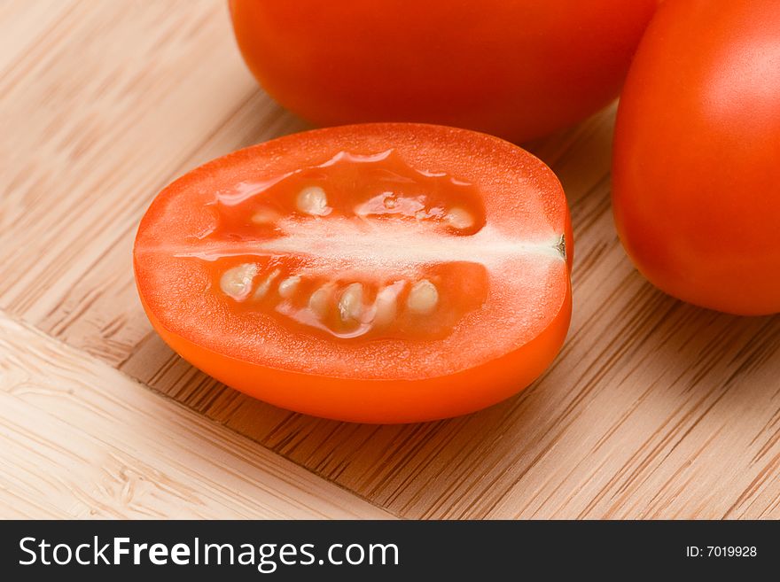 Cut tomatoes on chopping board.