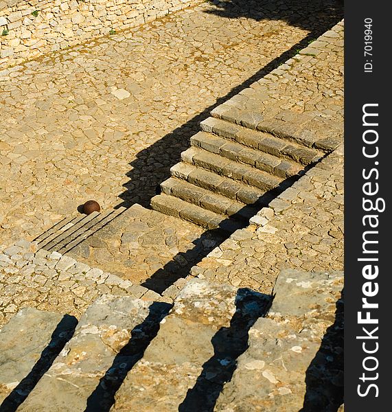 Geometric composition of steps at the Nafplio fortress, Castle Palamidi. Single canon ball at foot of the bottom step. Geometric composition of steps at the Nafplio fortress, Castle Palamidi. Single canon ball at foot of the bottom step.