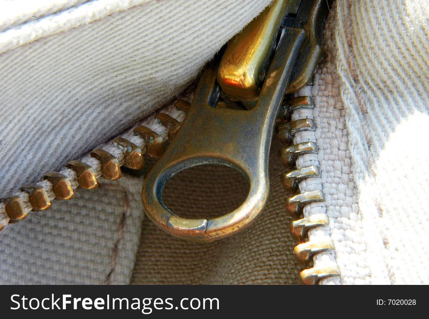 A macro closeup shot of a zipper and heavy weave cotton. A macro closeup shot of a zipper and heavy weave cotton