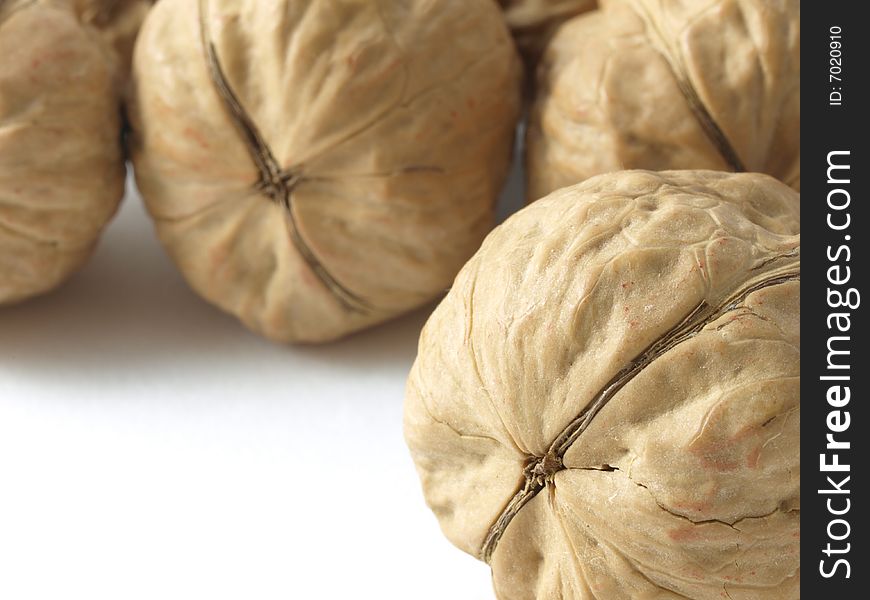 Close-up of a walnut with walnuts as a background. Close-up of a walnut with walnuts as a background.