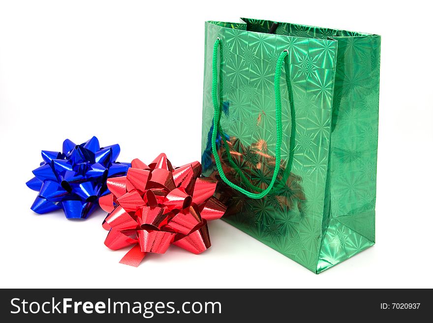 Green package and two bows on isolated