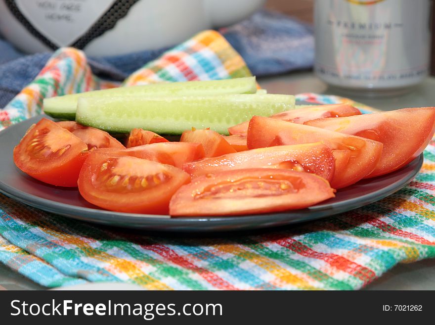Cucumbers, tomatoes cut slices on a plate. Cucumbers, tomatoes cut slices on a plate