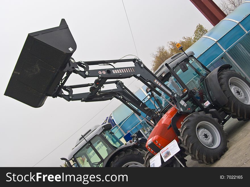 Backhoe on an agricultural tractor at an exihibition