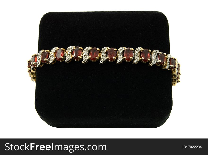 Garnet and diamond gold bracelet set on a black velvet box