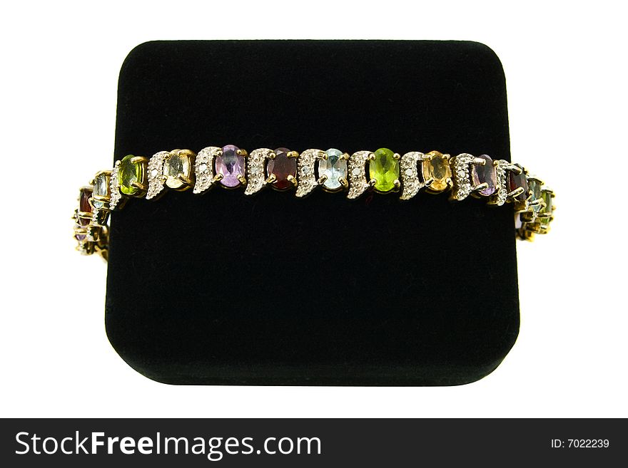 Multi-colored gemstone bracelet on a black velvet box