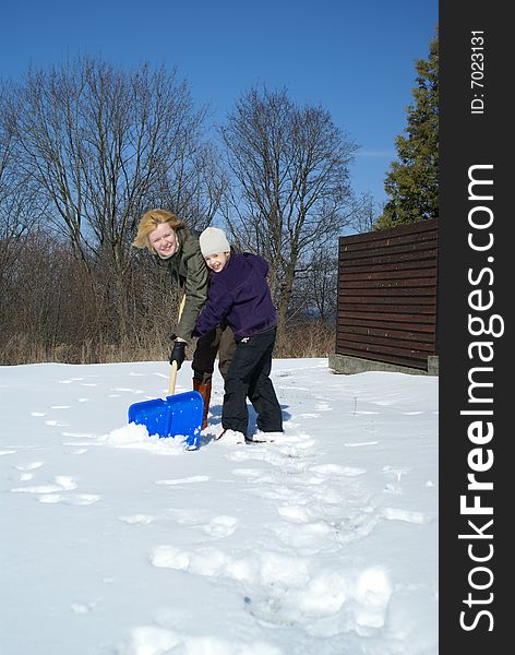 Mother and her daughter throw up snow on a winter background. Mother and her daughter throw up snow on a winter background