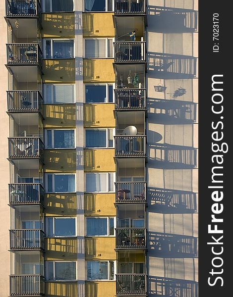 Balconies casting a shadow on the wall.