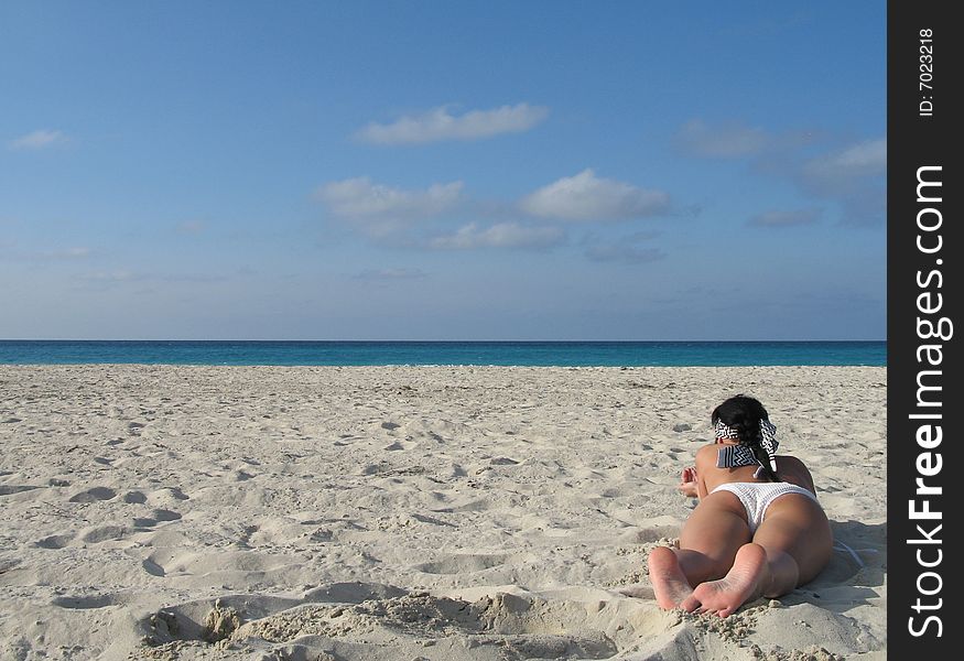 Female in a white bikini on the beach