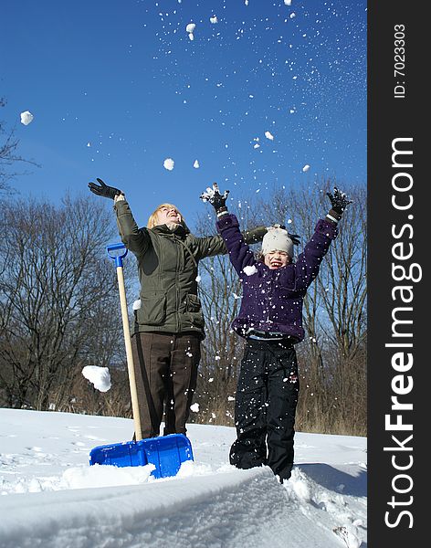 Mother And Her Daughter On A Winter Background