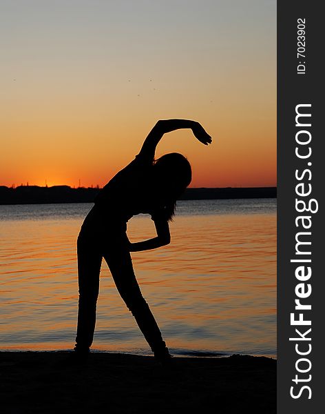 Girl doing exercises on the beach. Girl doing exercises on the beach