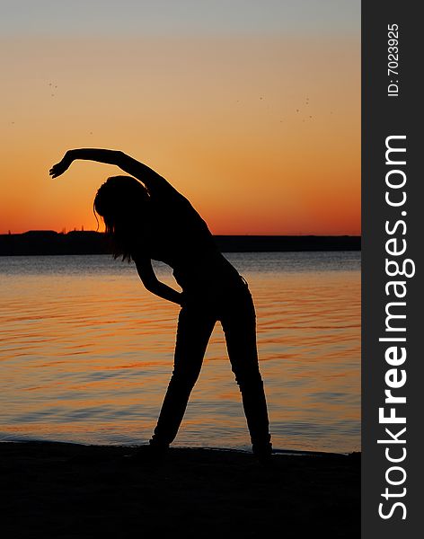 Girl doing exercises on the beach. Girl doing exercises on the beach