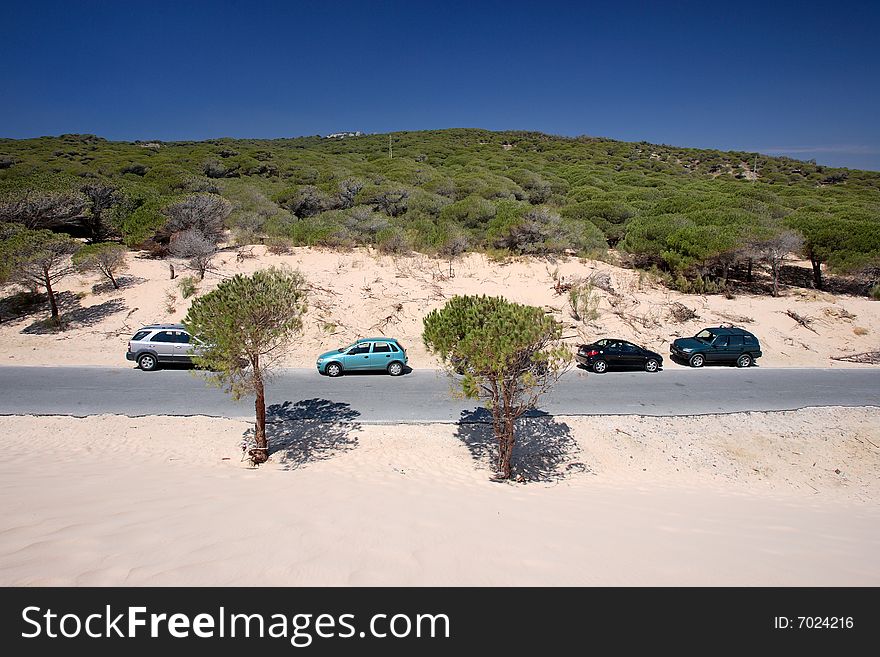 Cars parked on sand dunes at Tarifa beach in Spain