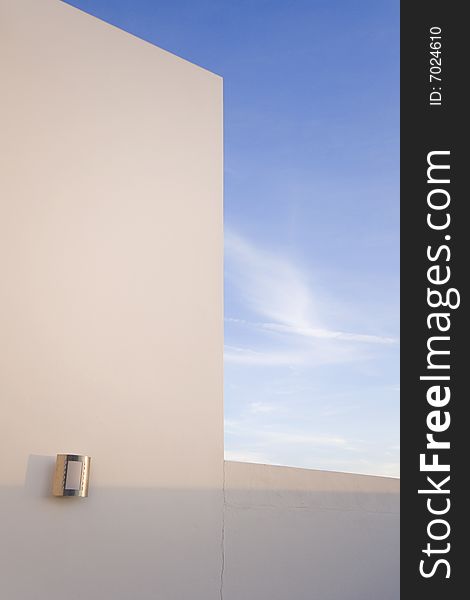 Detail of the facade of a modern house with a blue sky. Detail of the facade of a modern house with a blue sky