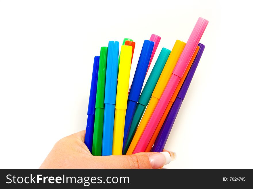Multi colored highlighters in female hand on white background. Multi colored highlighters in female hand on white background