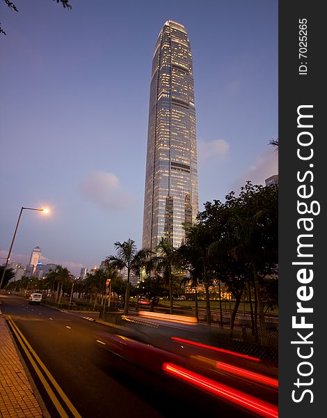 IFC building Hong Kong with speed blur taxi in foreground. IFC building Hong Kong with speed blur taxi in foreground