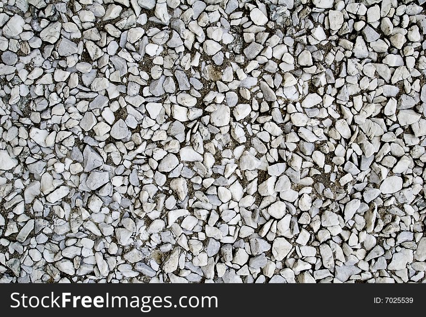 Background of a wall of white and gray rocks. Background of a wall of white and gray rocks