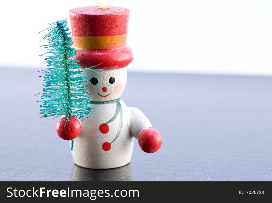 A Snowman carrying a tree on icey background. A Snowman carrying a tree on icey background.
