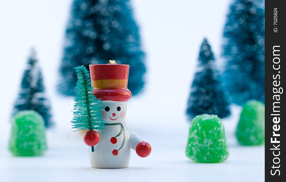 Snowman in Snow with Trees and Gumdrops in Background. Snowman in Snow with Trees and Gumdrops in Background