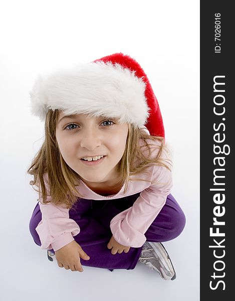 Sweet girl with christmas hat looking you against white background