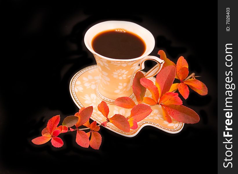 Cup hot tasty coffee with autumn beautiful branch on black background. Cup hot tasty coffee with autumn beautiful branch on black background